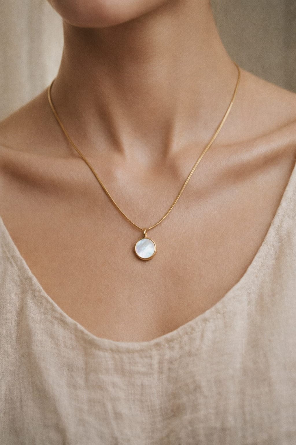 Woman wearing a Memoura circle pendant