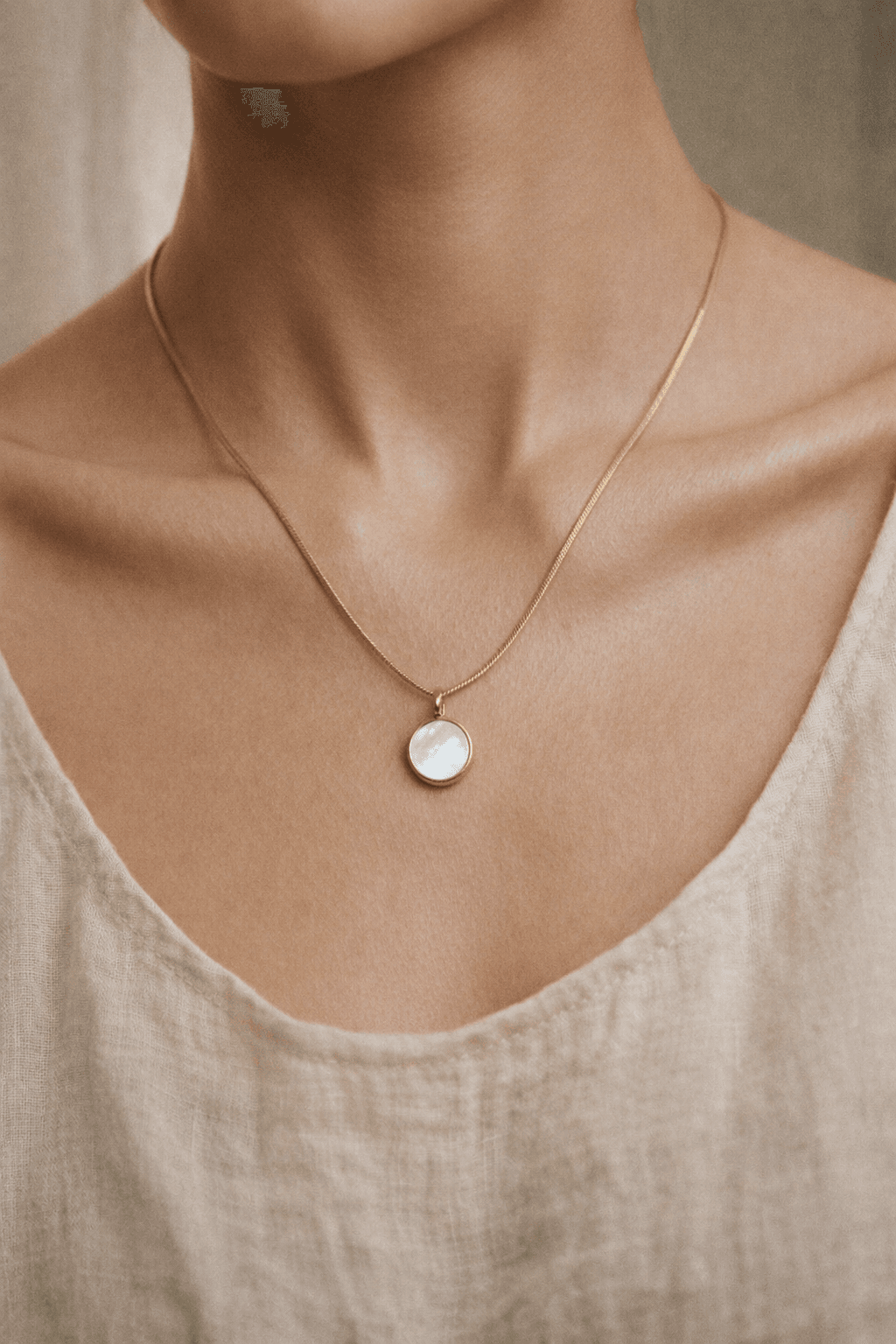 Woman wearing a Memoura circle pendant necklace