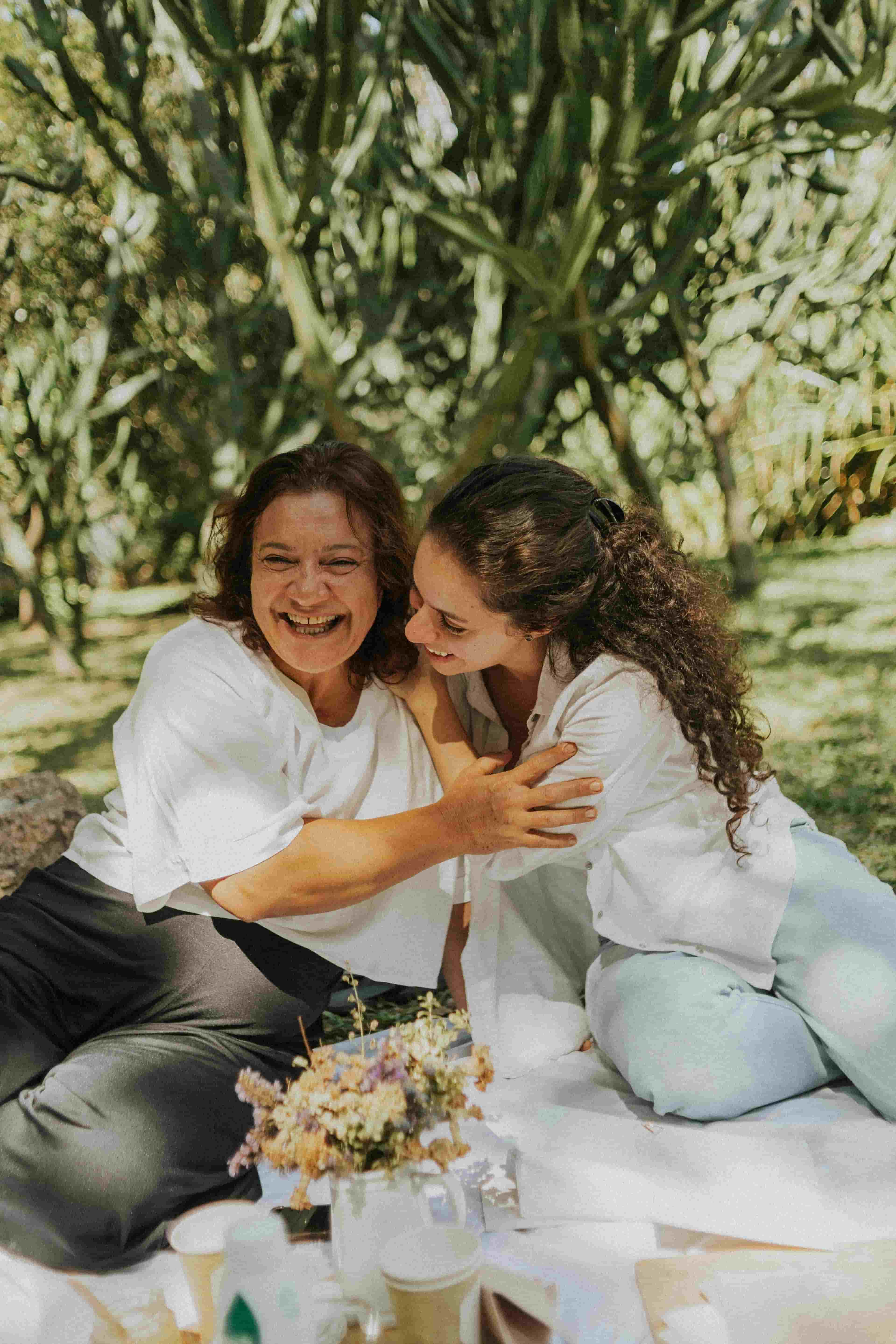 A mother and her adult daughter laughing together